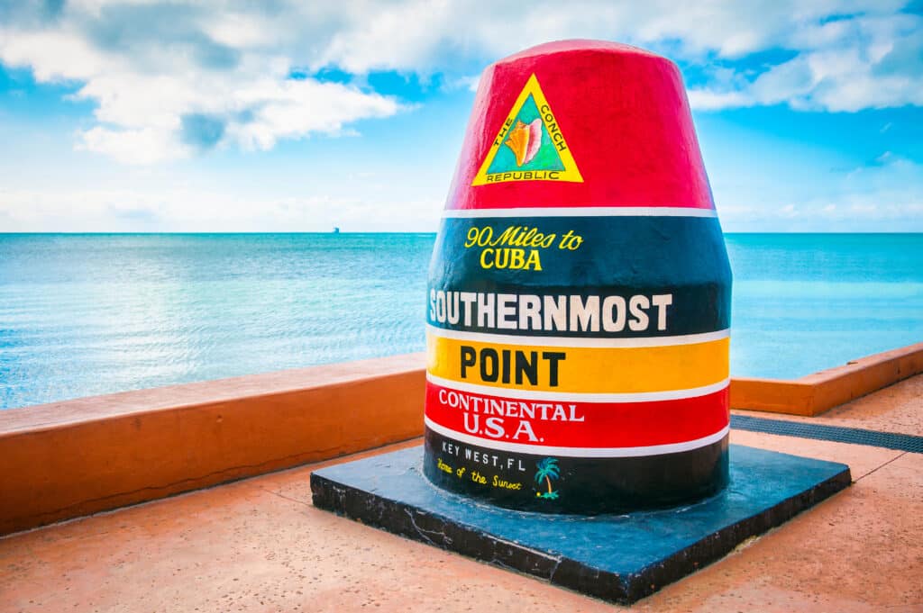 Empty scenic view of the colorful concrete buoy marking the southernmost point of the continental USA in Key West, Florida